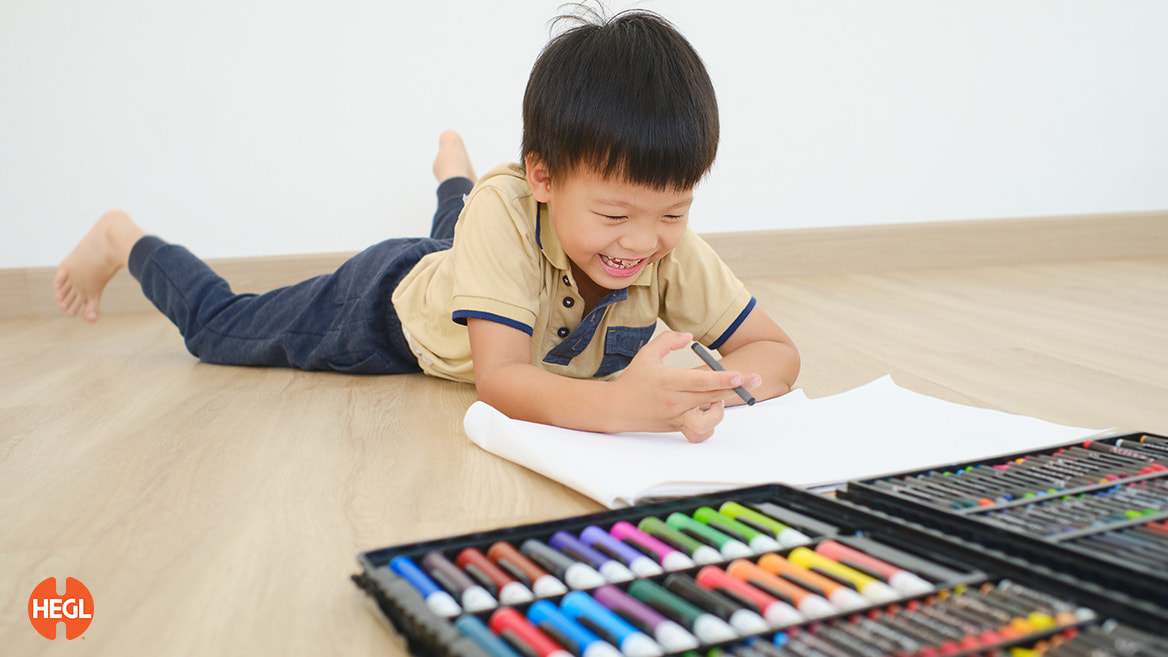 an asian child happily drawing improves right brain training